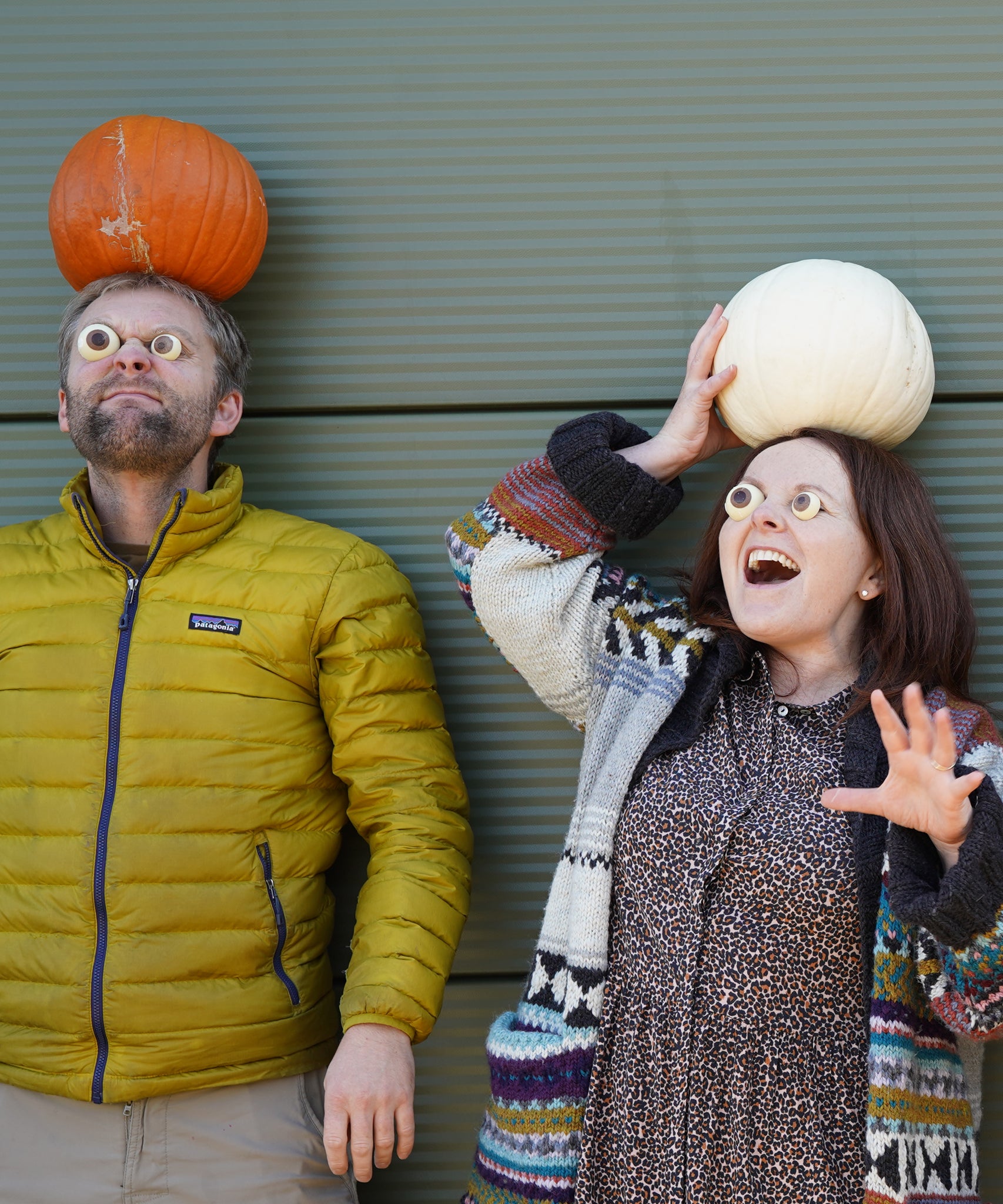 Cocoa Loco Halloween eyeball chocolate worn by Jolene and Pete from team Babipur. They're outside pulling spooky faces with pumpkins on their heads.