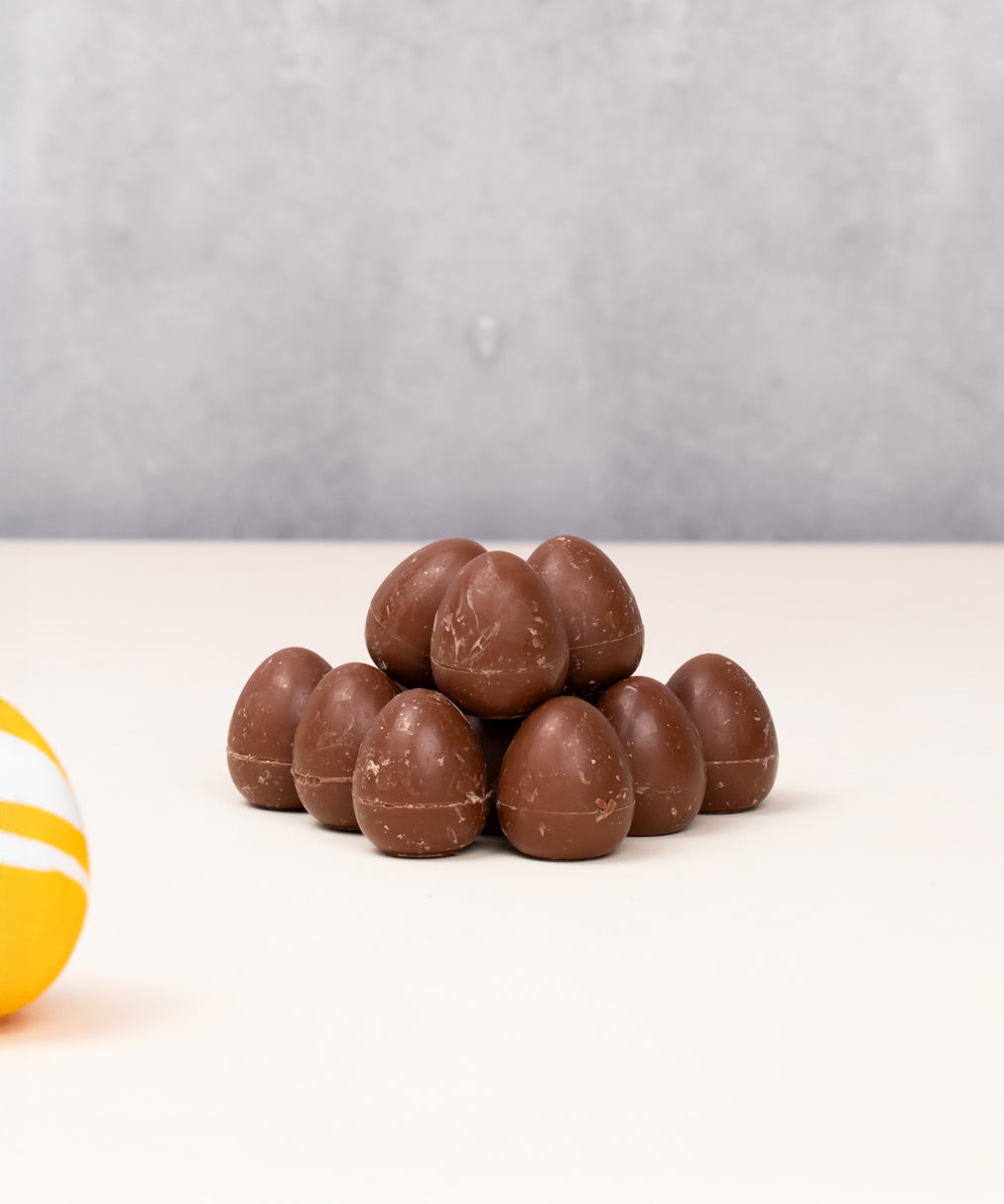 Cocoa Loco organic Fairtrade mini milk chocolate eggs. A colourful easter egg is in the frame to add a springtime feel.