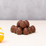 Cocoa Loco organic Fairtrade mini milk chocolate eggs. A colourful easter egg is in the frame to add a springtime feel.