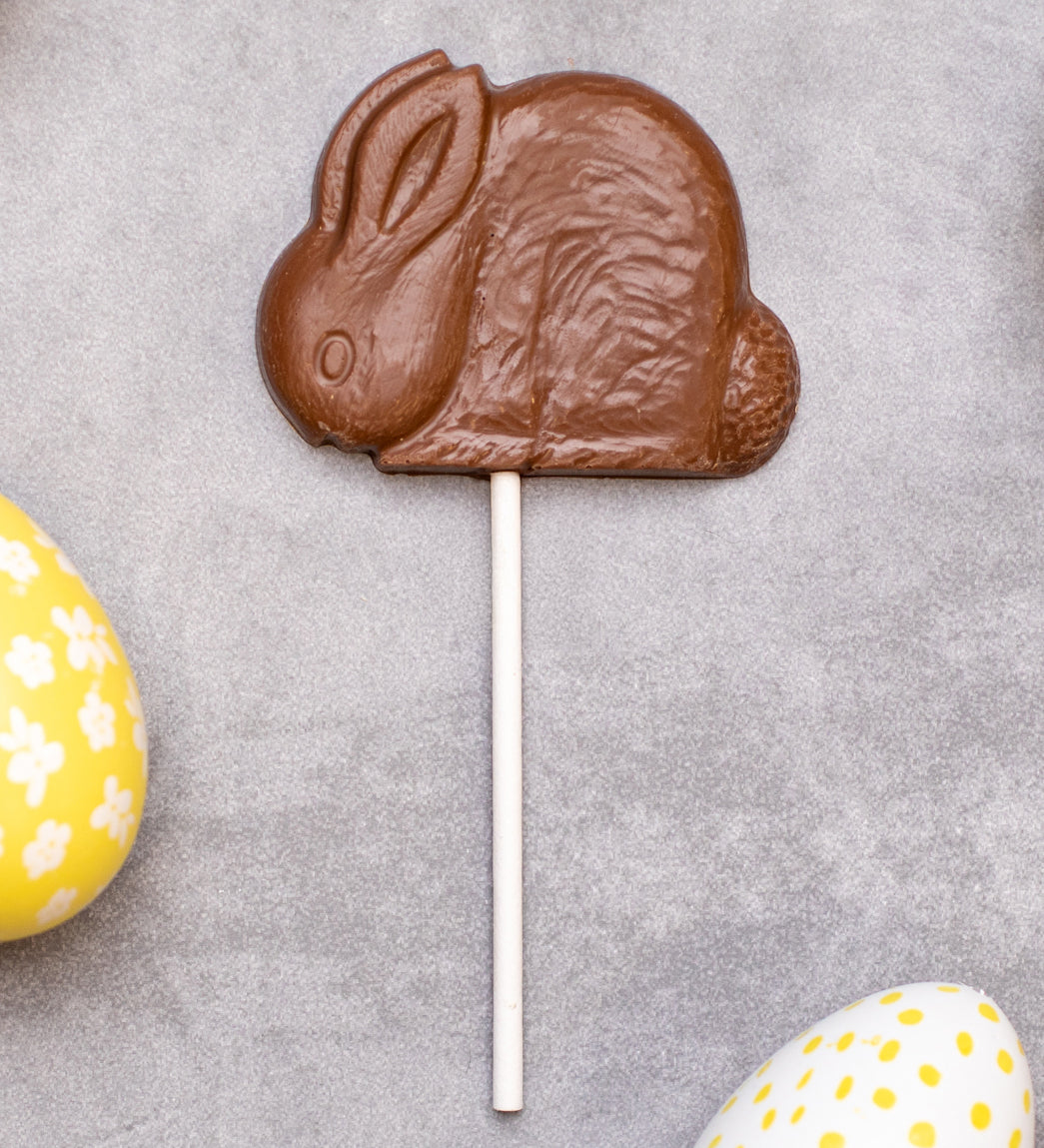 Cocoa Loco organic Fairtrade milk chocolate shaped rabbit lolly. Surrounded by colourful mini easter eggs.