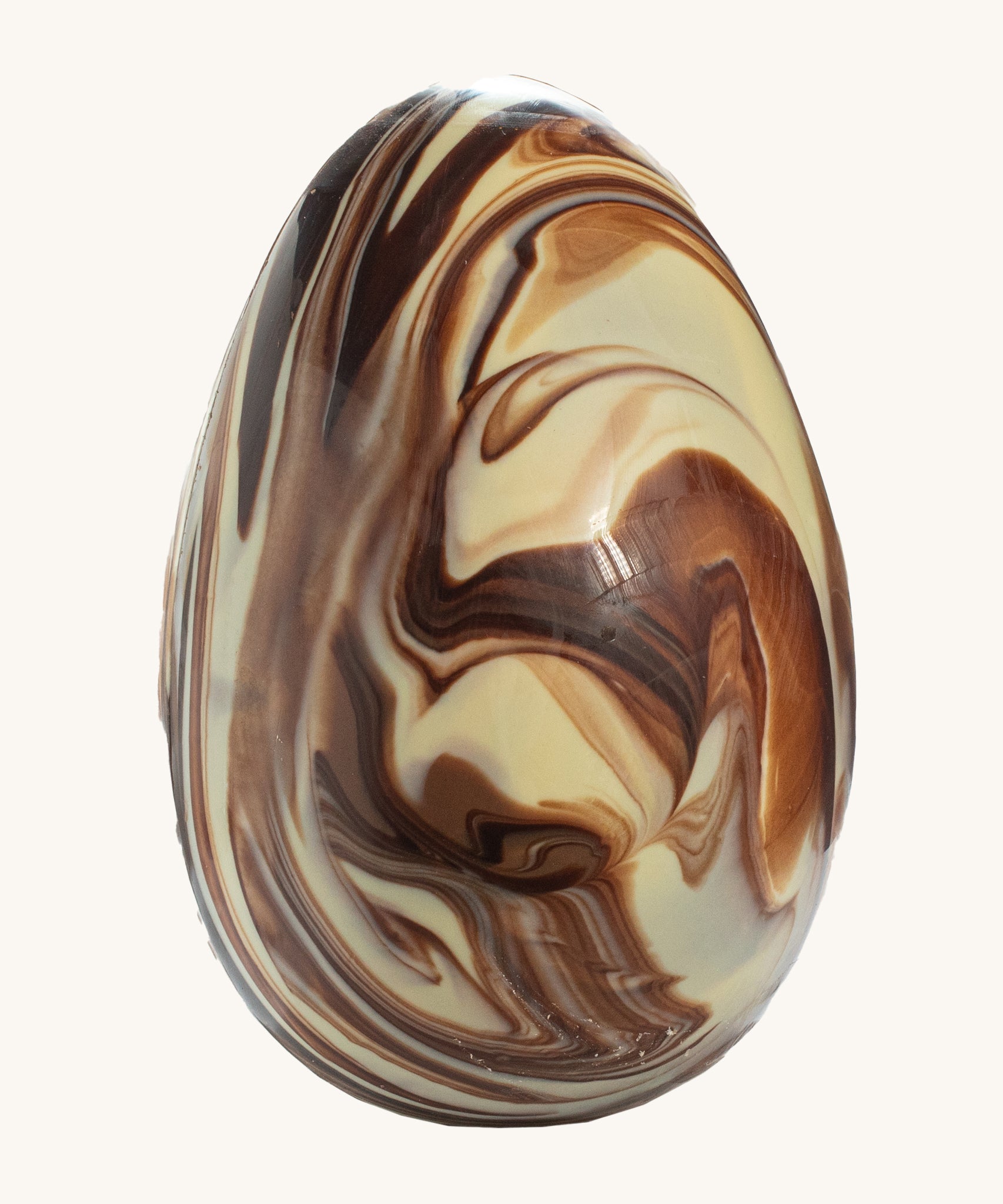 Cocoa Loco organic Fairtrade marbled Easter egg, a handmade blend of milk, dark, and white chocolate with a striking swirl effect.