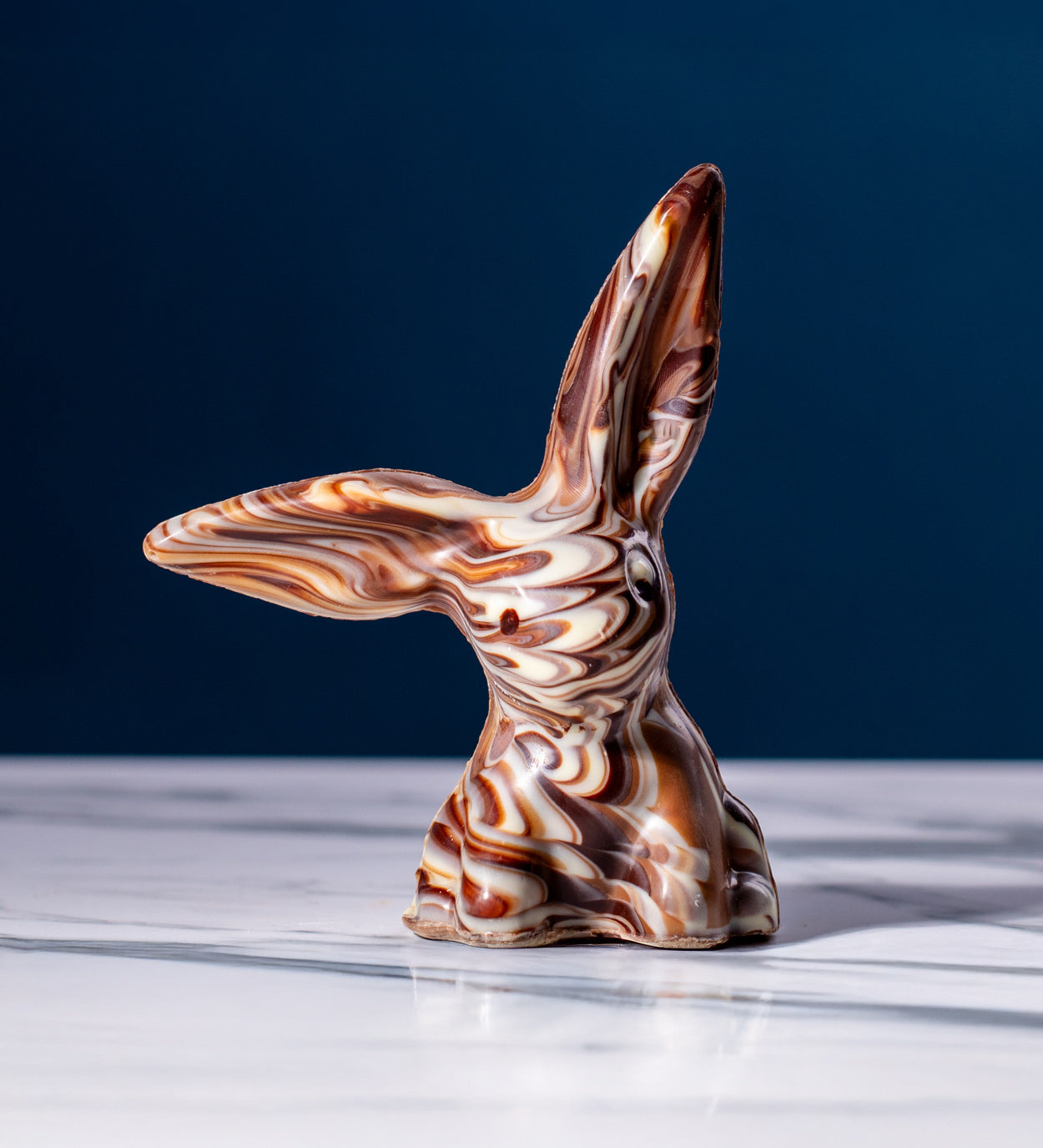 Cocoa Loco Marbled Fairtrade Chocolate Rabbit, a handmade blend of milk, dark and white chocolate with a striking swirl effect.