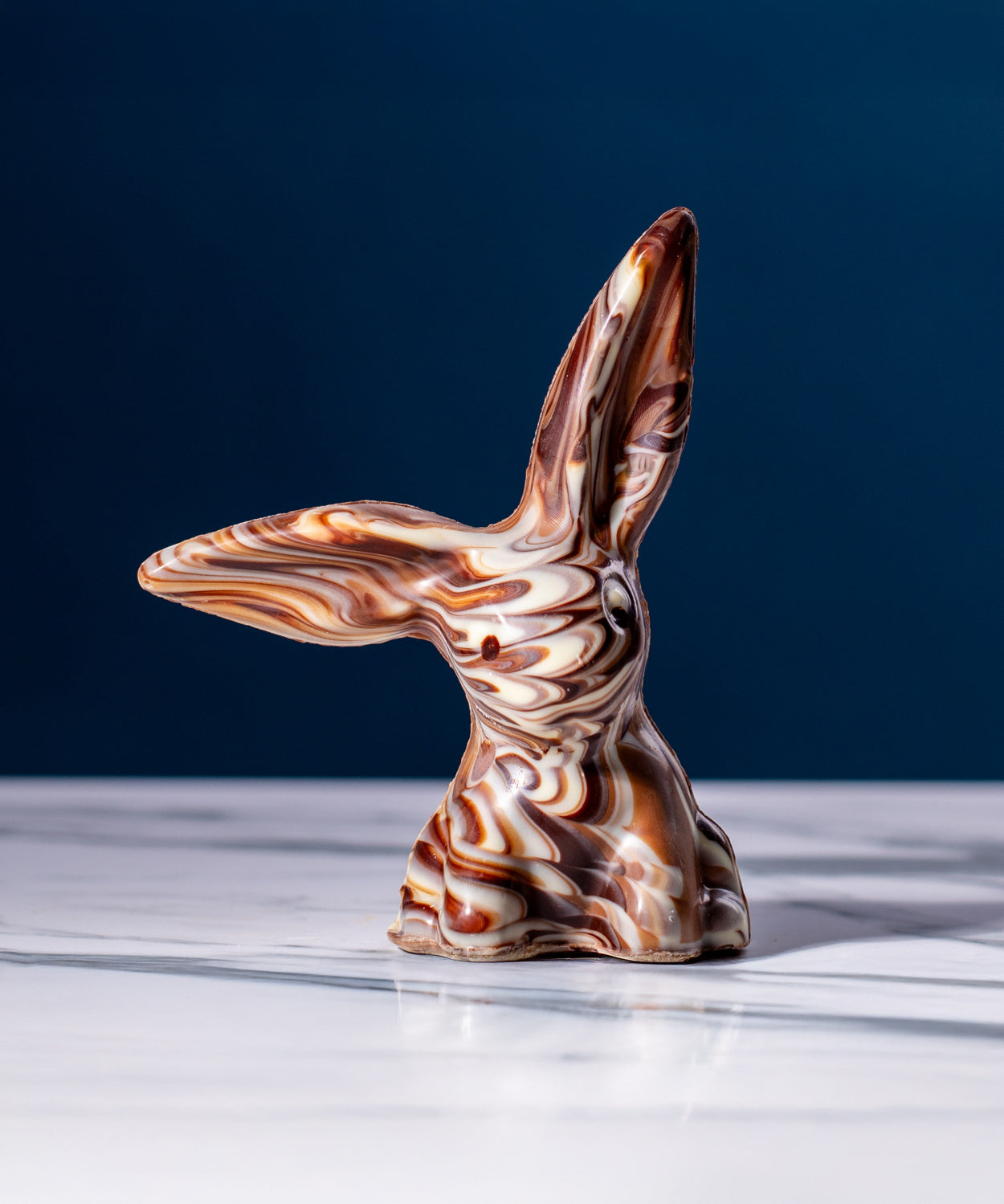 Cocoa Loco Marbled Fairtrade Chocolate Rabbit, a handmade blend of milk, dark and white chocolate with a striking swirl effect.