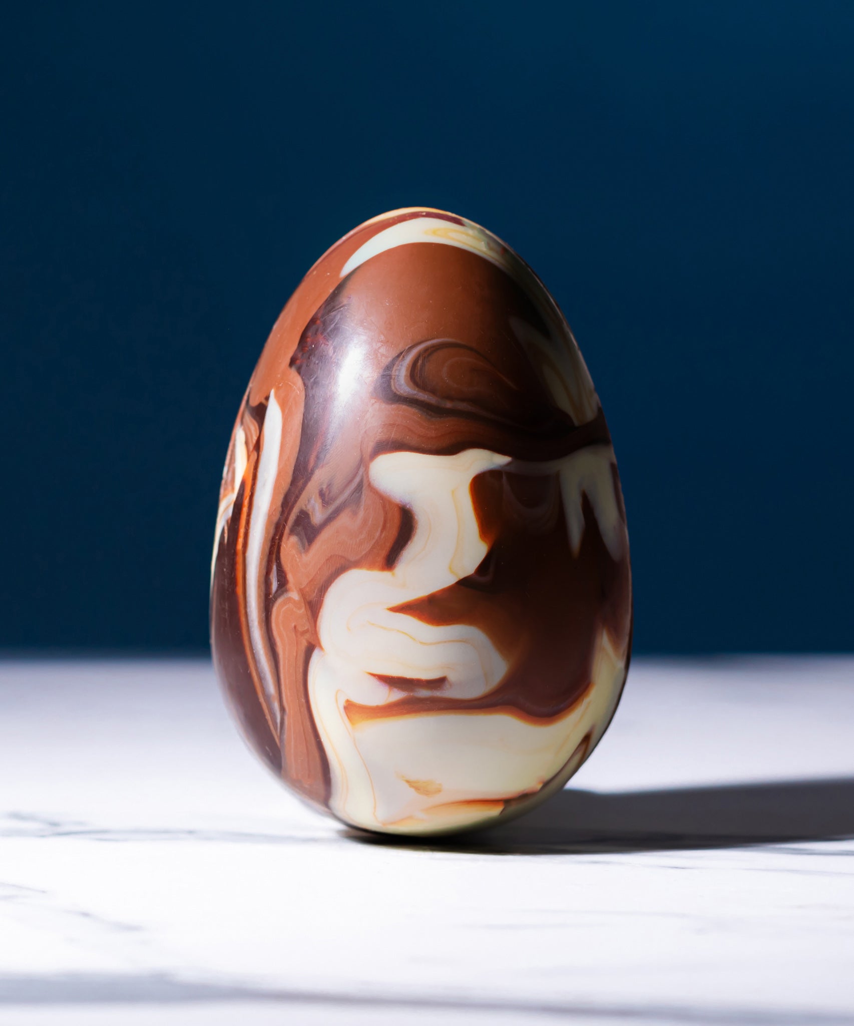 Cocoa Loco organic Fairtrade marbled Easter egg, a handmade blend of milk, dark, and white chocolate with a beautiful swirl effect. Made in the UK.