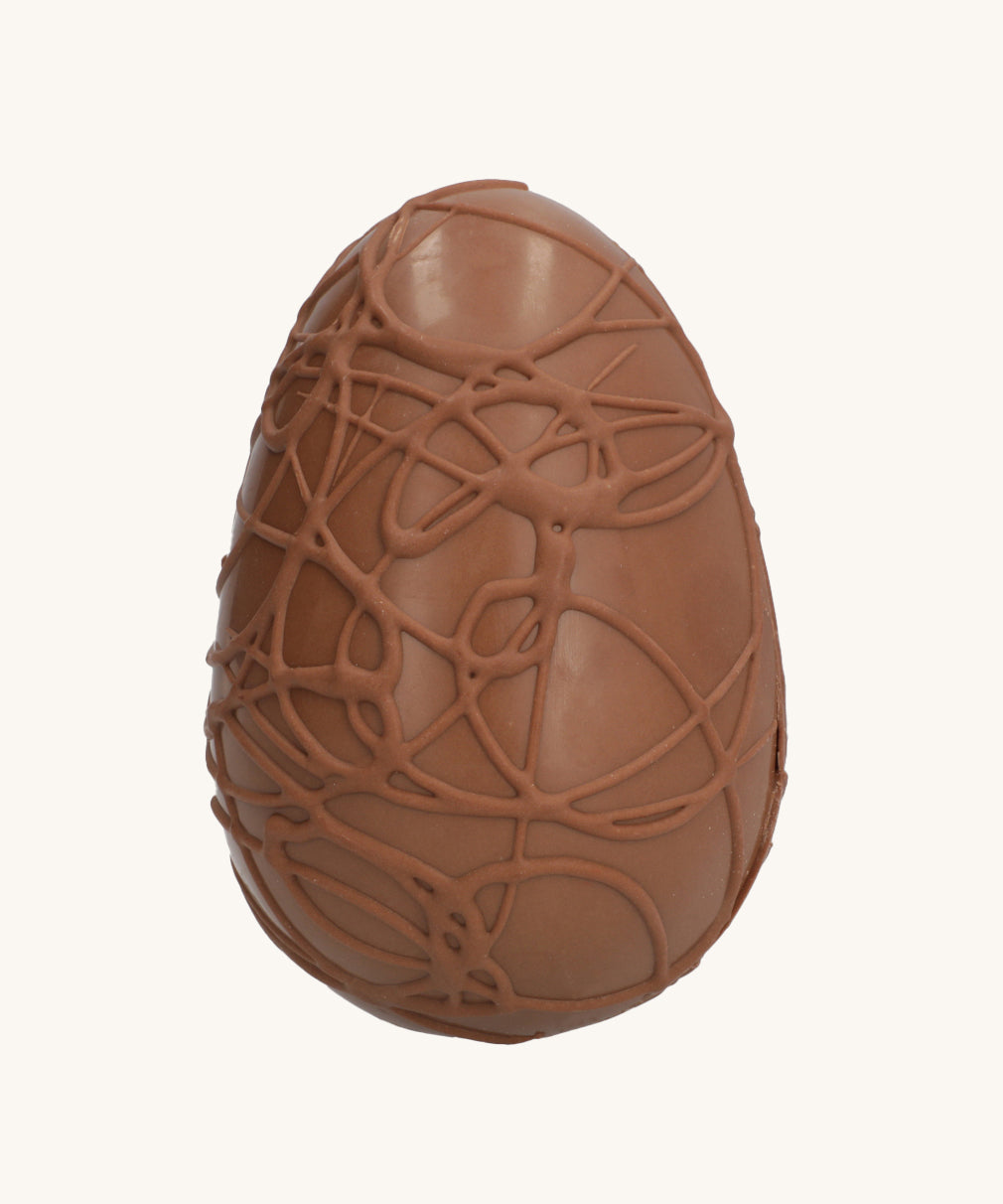 Cocoa Loco Fairtrade organic milk chocolate Easter egg, hand crafted with intricate chocolate swirls.