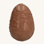 Cocoa Loco Fairtrade organic milk chocolate Easter egg, hand crafted with intricate chocolate swirls.