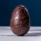 Cocoa Loco Fairtrade organic vegan dark chocolate Easter egg, hand decorated with intricate chocolate swirls.