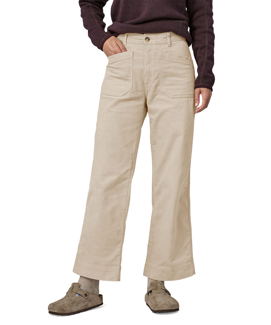 A person wearing thePatagonia Women's Wide Leg Cord Pants - Pumice, showing the flared style cut of the trouser legs