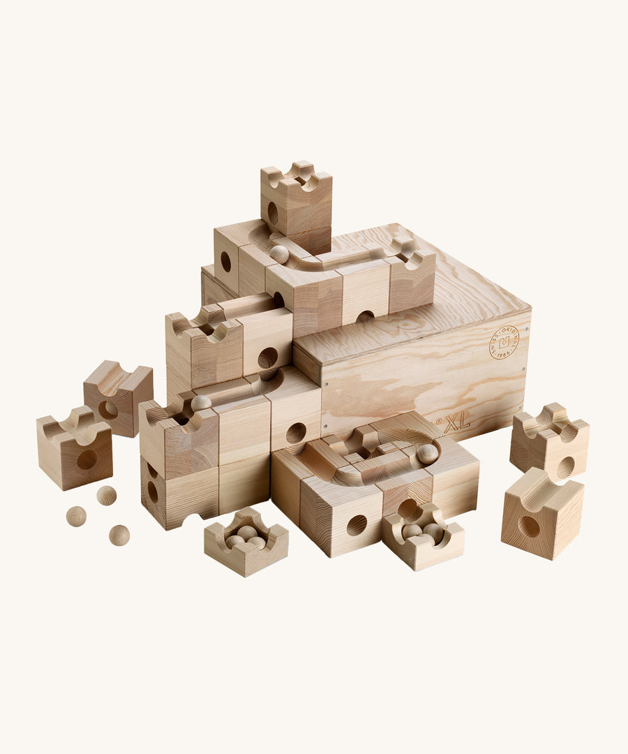 The Cuboro XL Wooden Marble Run Set with wooden marble balls rolling down the ball run grooves in the blocks