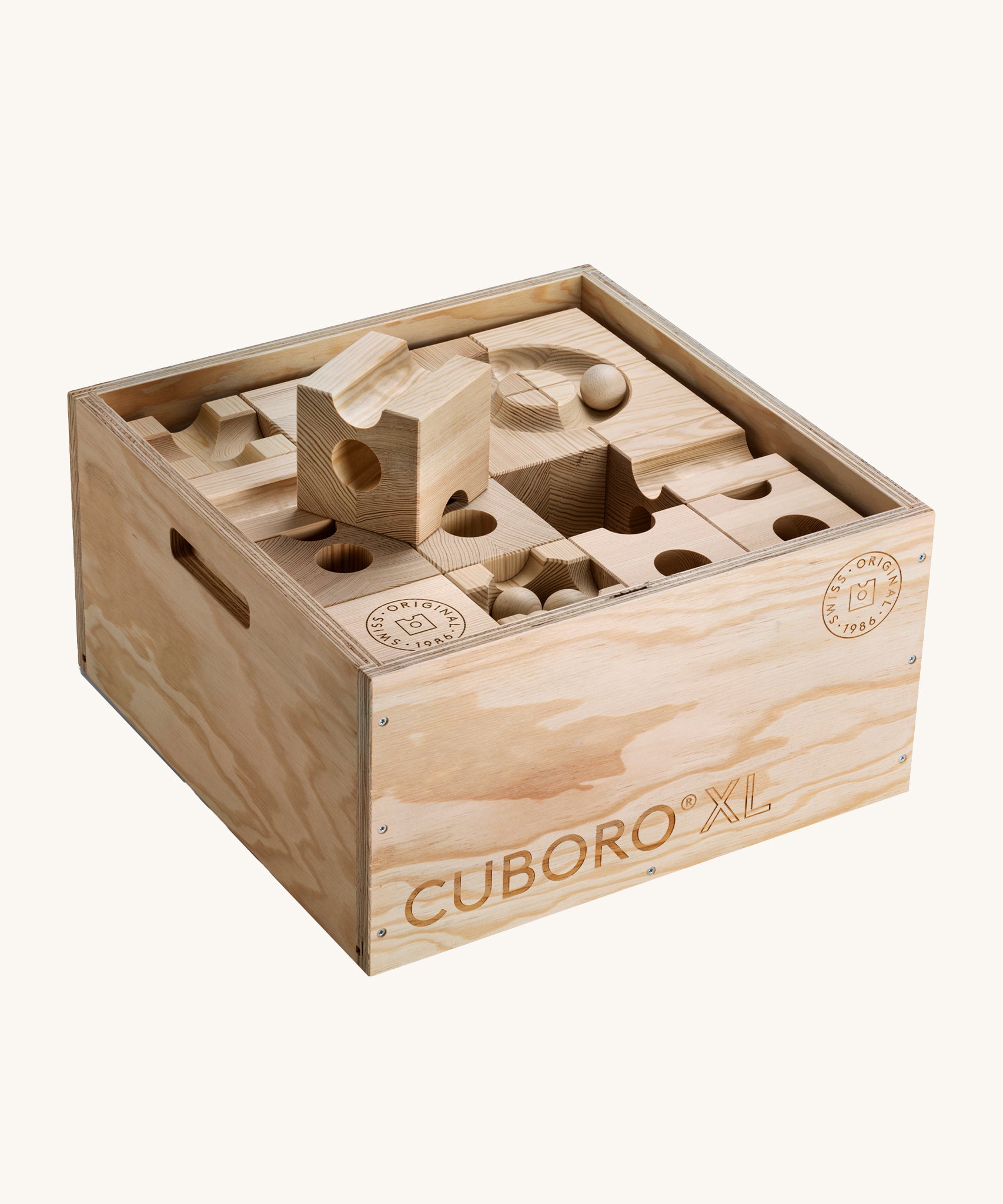 The Cuboro XL Wooden Marble Run Set inside its wooden box with the lid off. The image is on a cream background