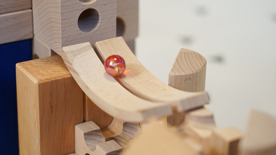 Close up picture of a Cuboro wooden toy set with a marble