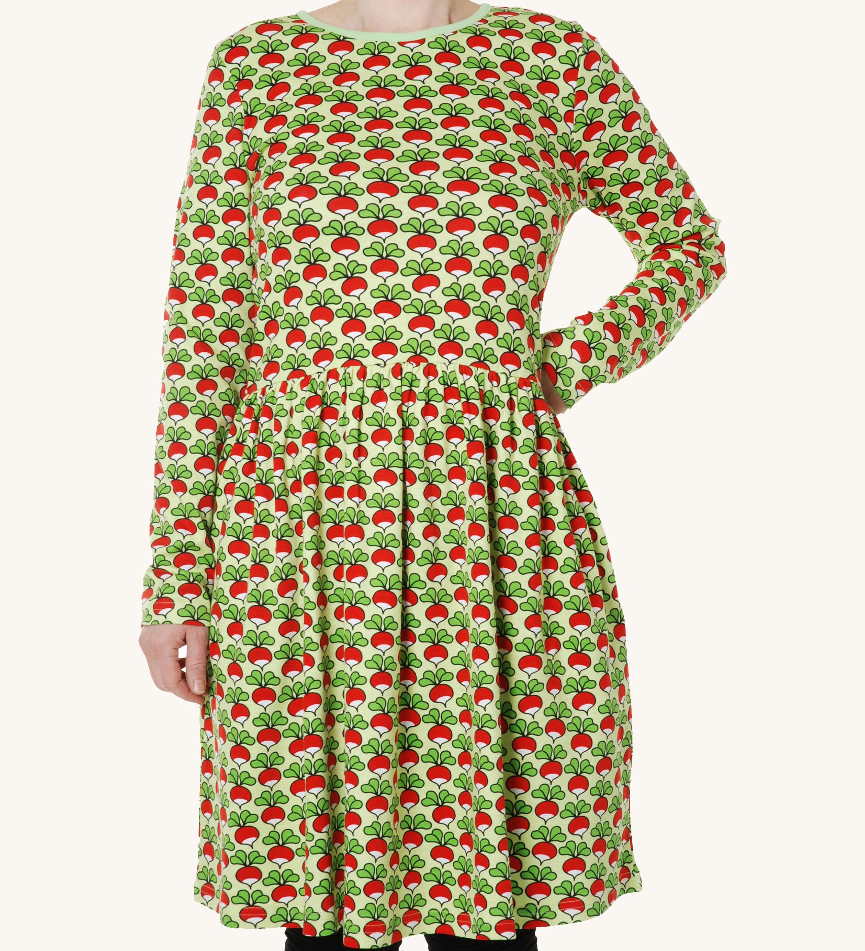 A light green fabric with fun repeat radish print