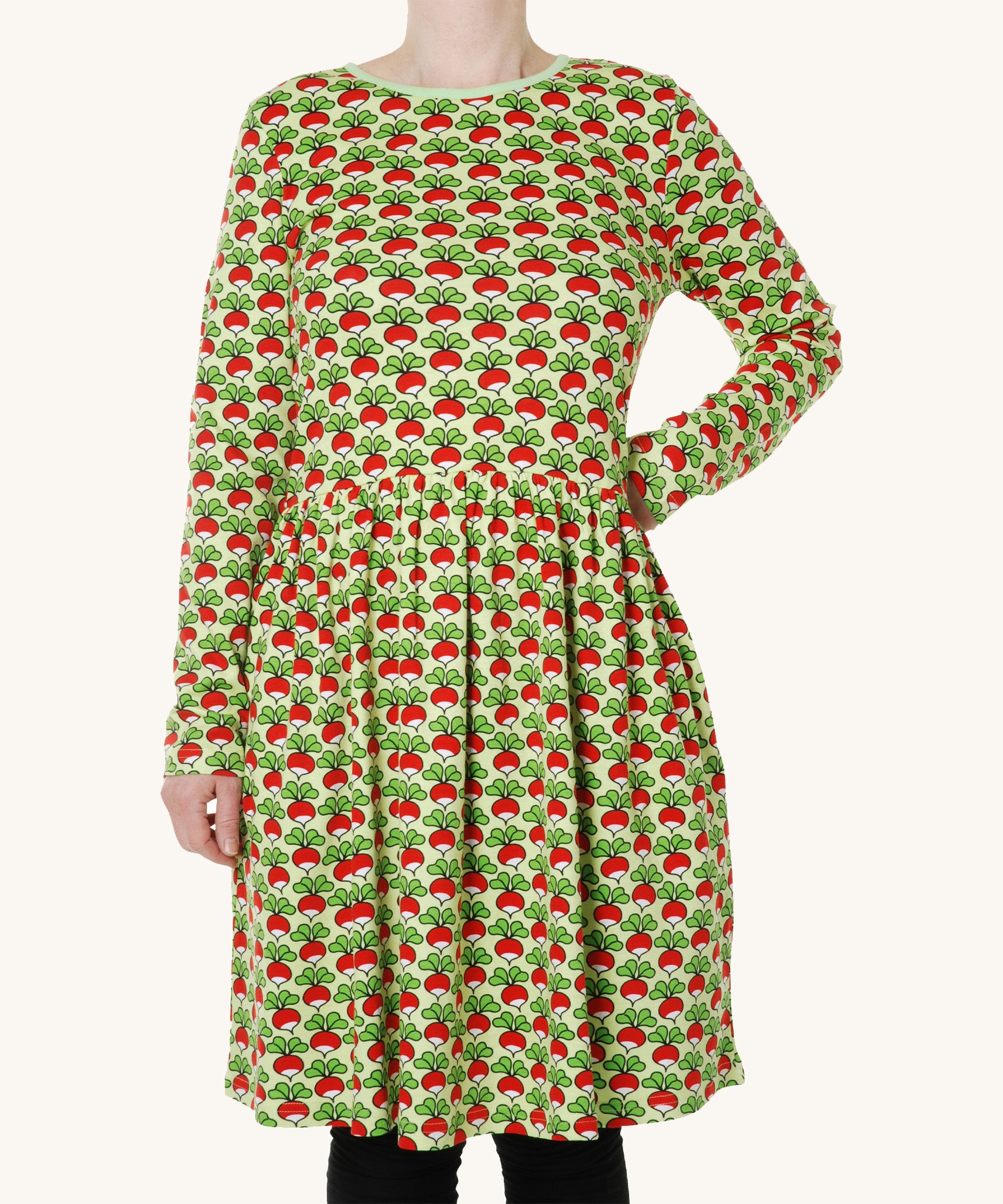 A light green fabric with fun repeat radish print