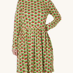 A light green fabric with fun repeat radish print