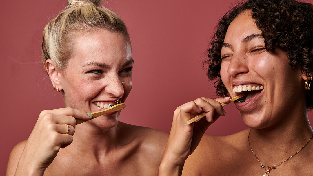 Women brushing their teeth using Denttabs toothpaste tablets