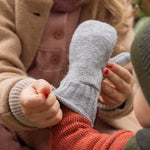 Disana merino wool grey mitten worn by a baby cuff detail