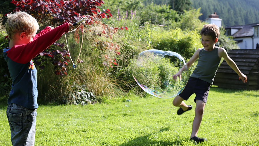 Children playing with a Dr Zigs giant bubble