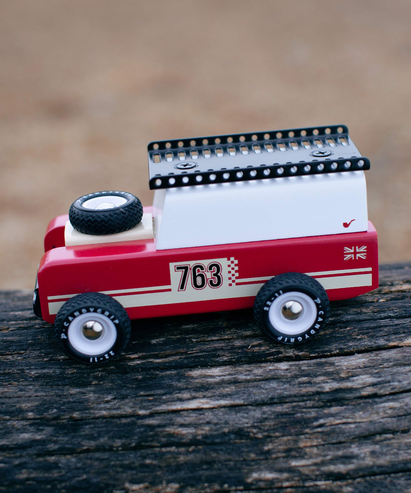 The Candylab Drifter Nigel on a wooden log, showing the car from the side