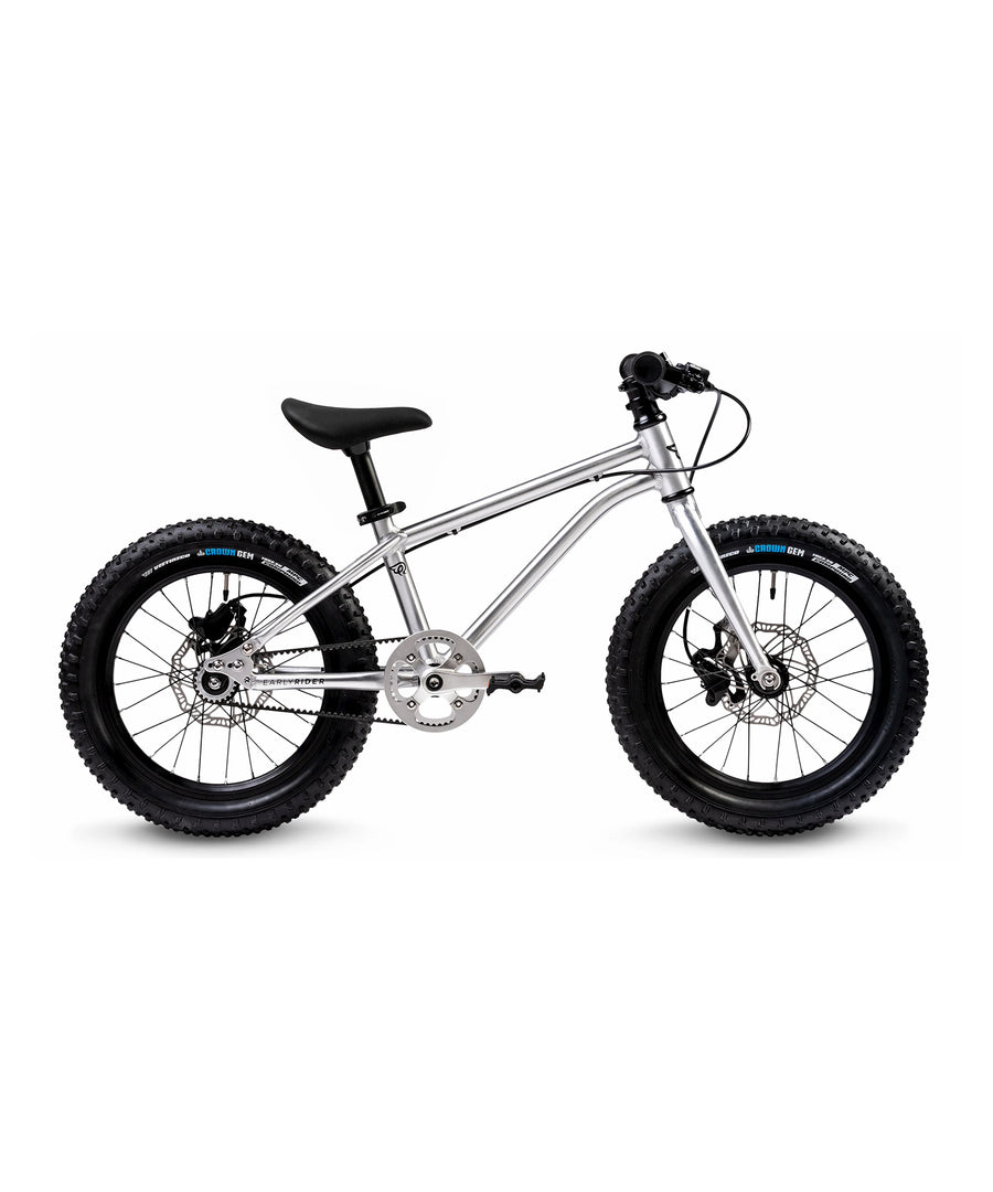 The Early Rider Seeker X16 16" Bike - Brushed Aluminium from the side, on a plain background