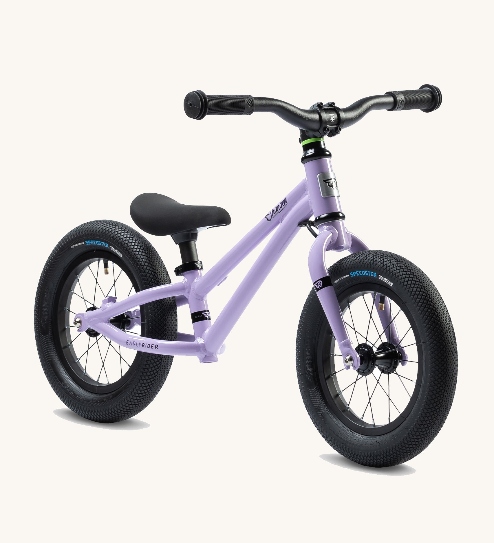 Early Rider Charger Balance Bike - Violet Haze, at a side on view. The balance bike has a violet low slung frame, chunky black wheels, a clack seat and black handle bars and is on a cream background