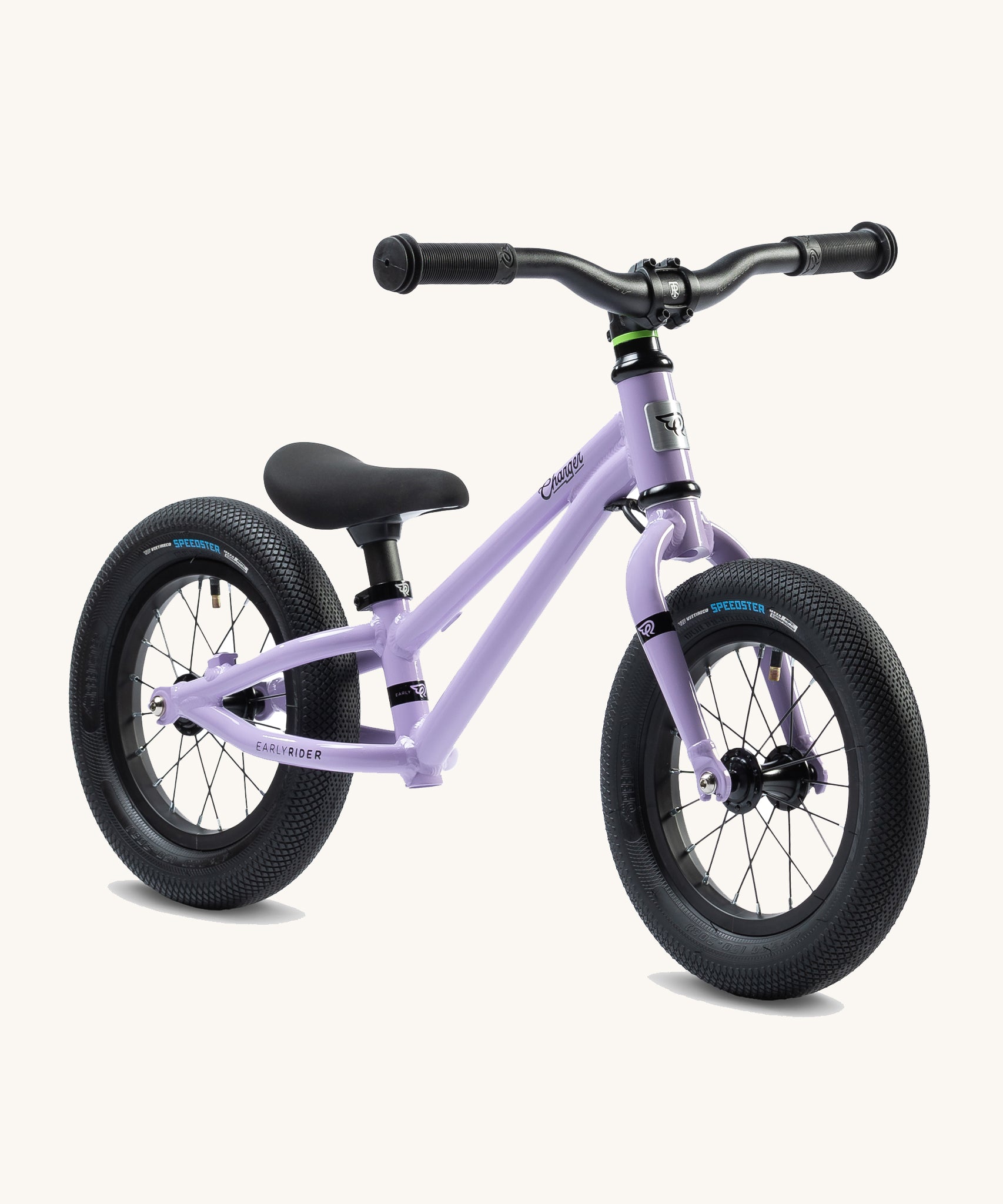 Early Rider Charger Balance Bike - Violet Haze, at a side on view. The balance bike has a violet low slung frame, chunky black wheels, a clack seat and black handle bars and is on a cream background