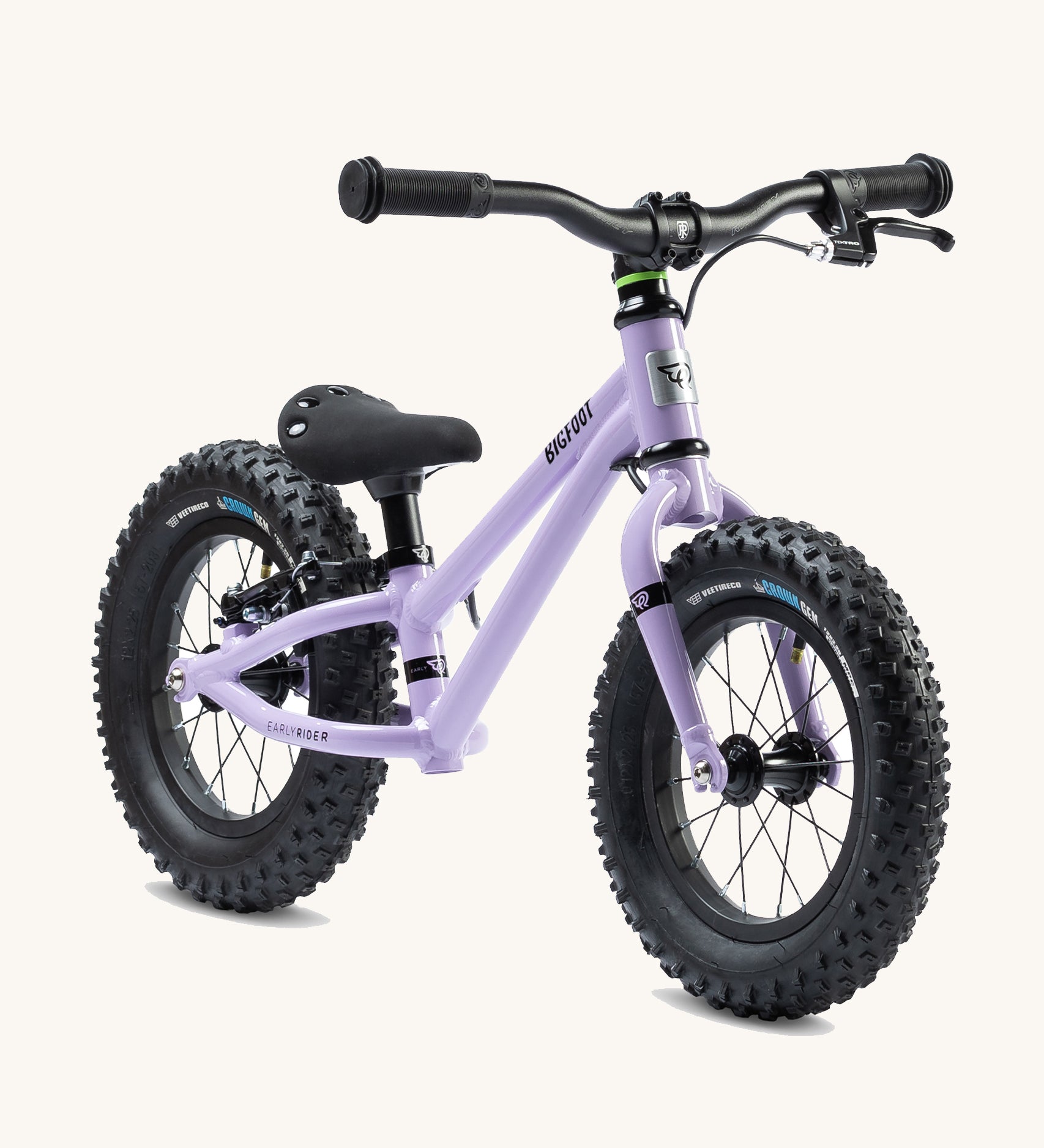 The Early Rider Big Foot Balance Bike - Violet Haze is stood at a slight angle. It has a Violet frame, black wheels, a black seat and black handle bars. The image is on a cream background