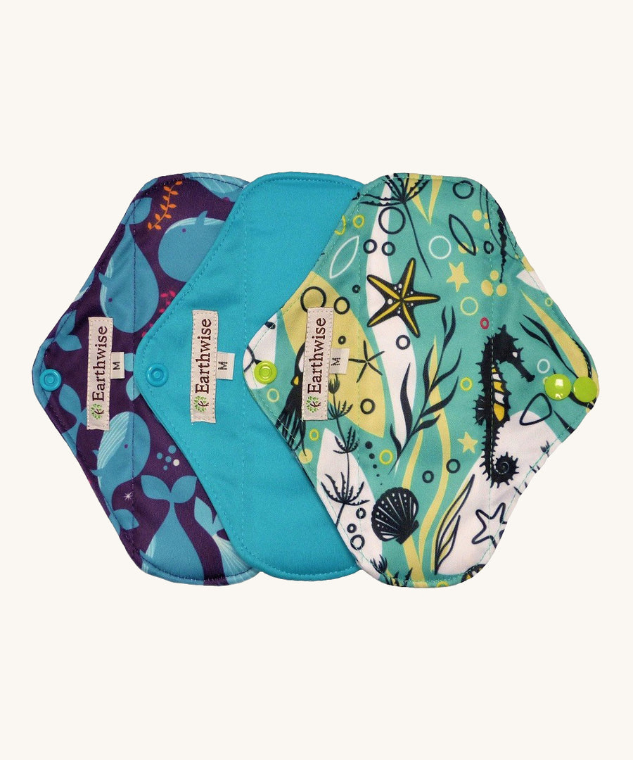 Three Earthwise reusable pads in blue underwater prints.