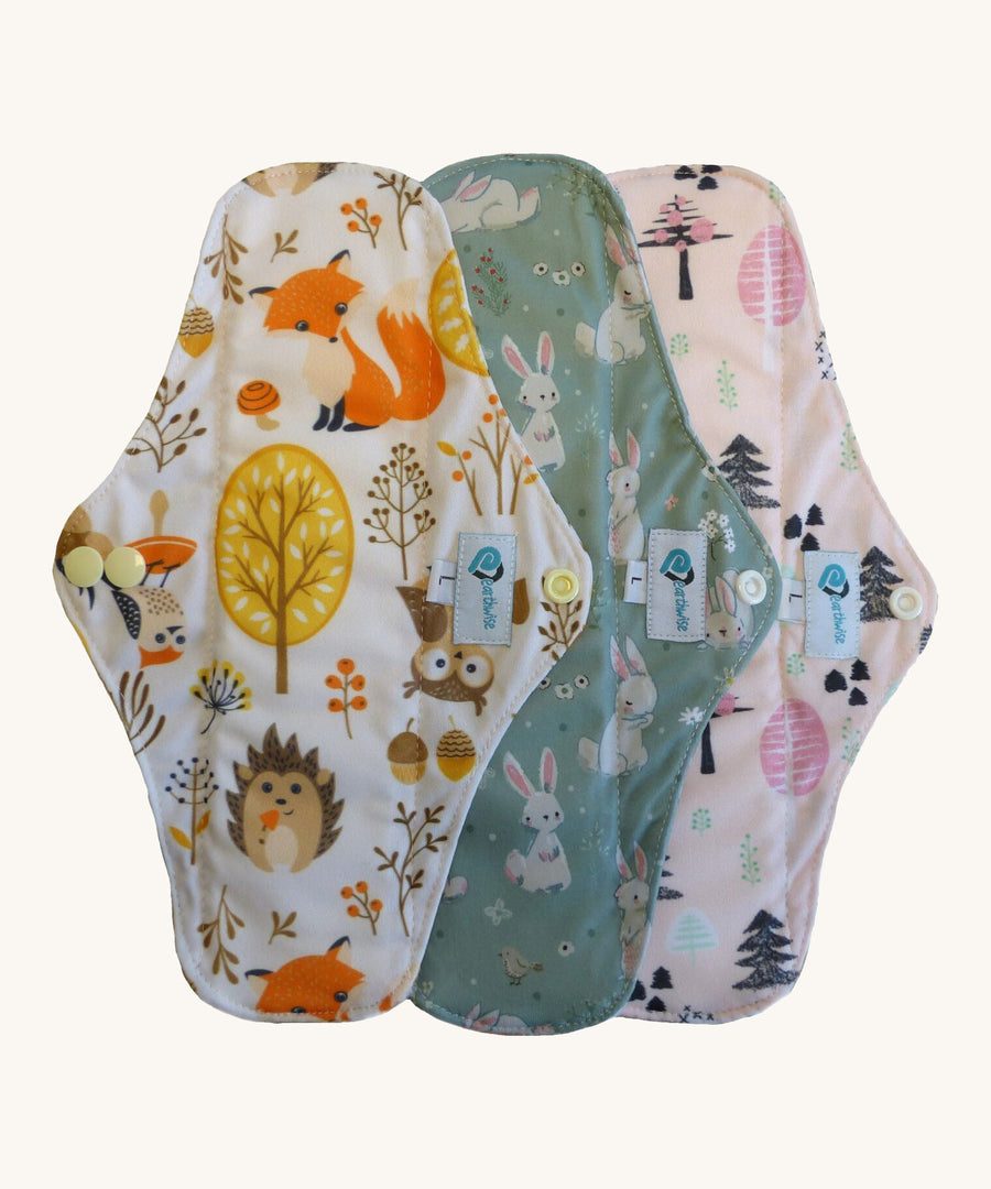 Three Earthwise reusable period pads in cute woodland prints.