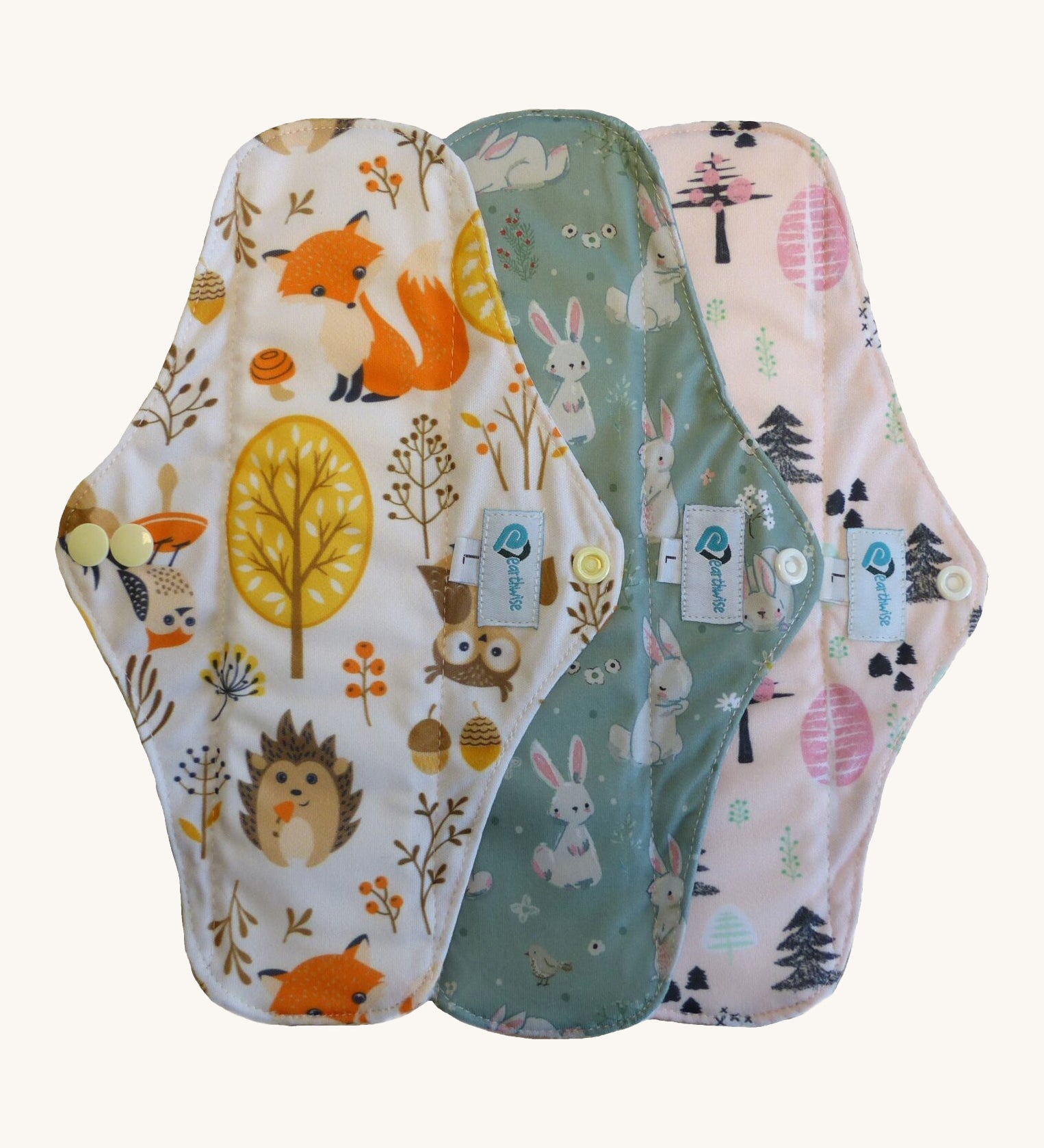 Three Earthwise reusable period pads in cute woodland prints.