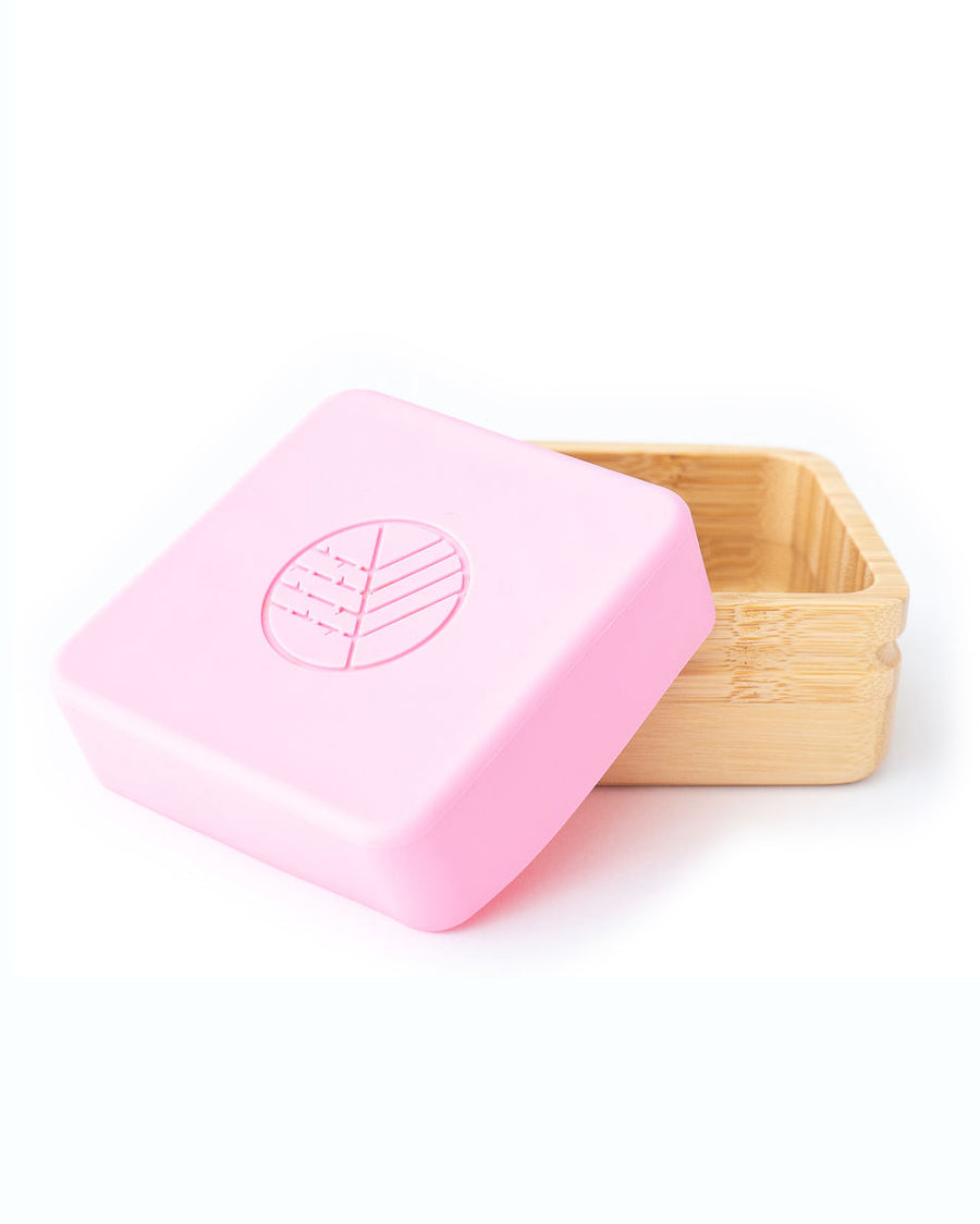 Square bamboo snack pot with a pink silicone lid half on the pot. 