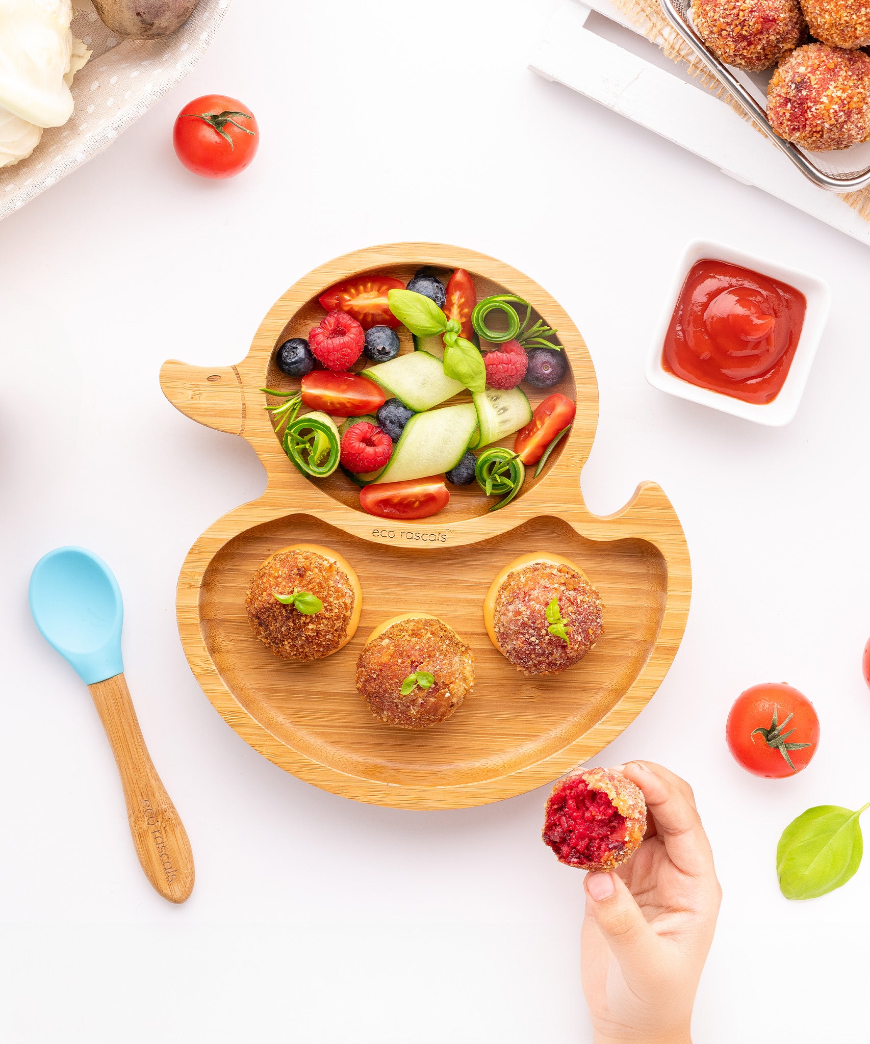 Eco Rascals Duck Bamboo Suction Plate, with fresh fruit and savory buns, and a tomato sauce. 