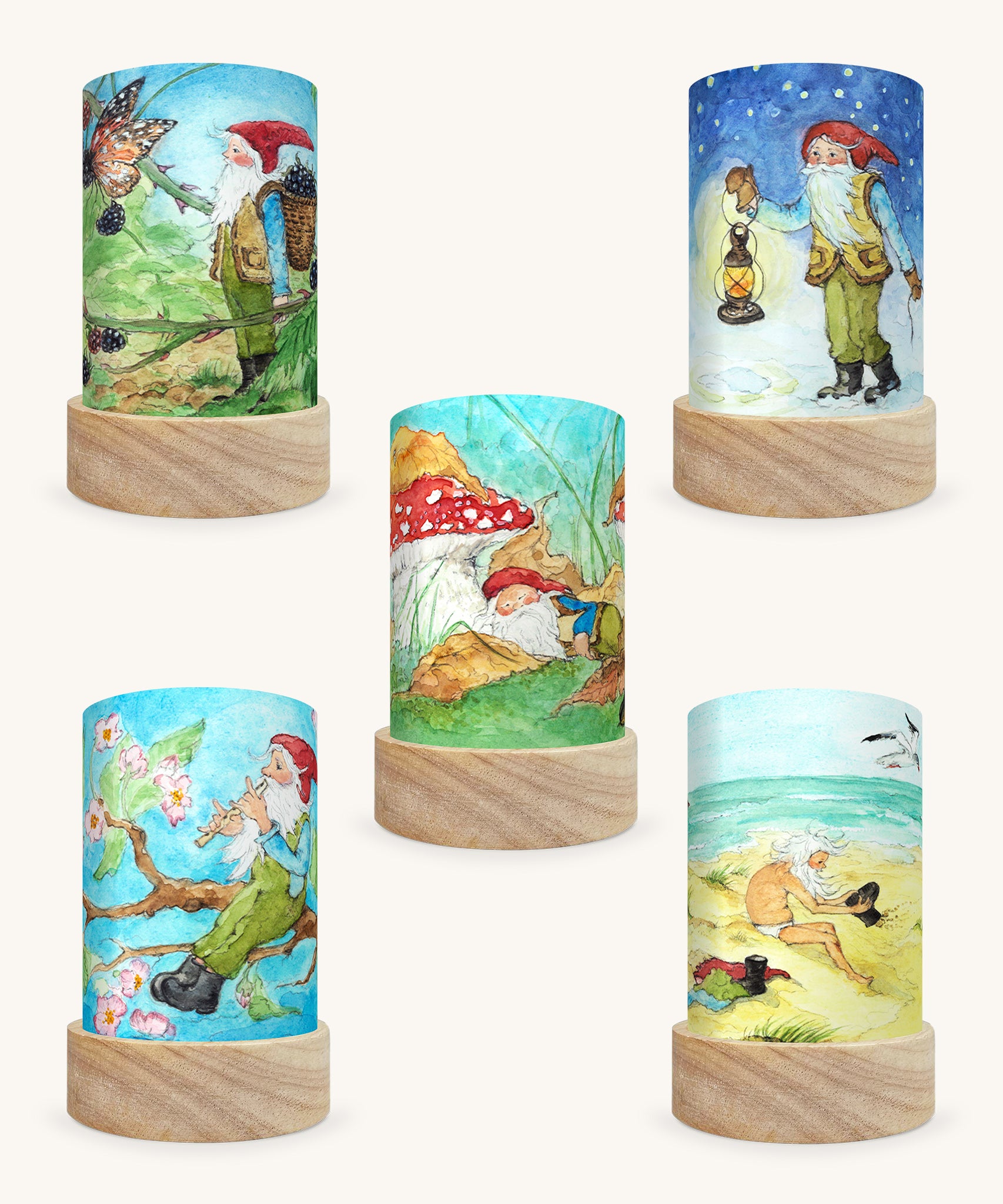 The George The Gnome Illustration Set by Eentje Van Margo, featuring 5 different Toverlux Magic Lantern Silhouettes which are: Gnome Spring, Gnome Summer, Gnome Sea, Gnome Autumn, Gnome Winter. The image is on a cream background.