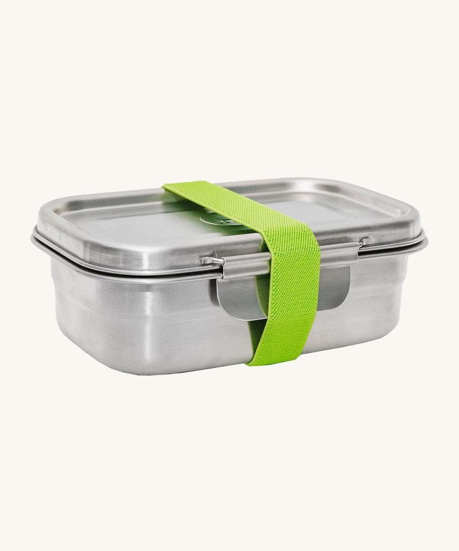 A green strap holding the Elephant Box Clip & Seal Lunchbox With Removable Divider - 800ml box and lid on a cream background