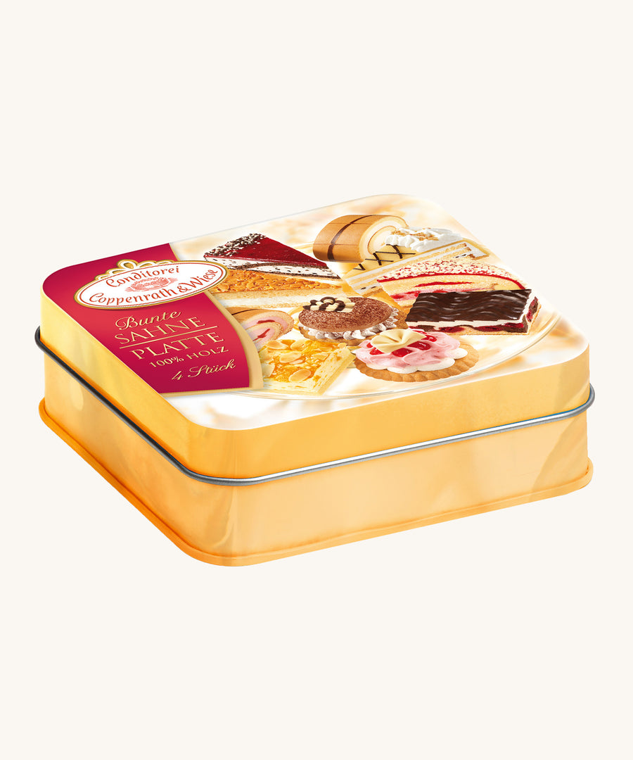 Erzi Wooden Cream Pastries In A Tin. A closer look at the decorative metal tin, in a golden colour with a real life photo of cakes on the front