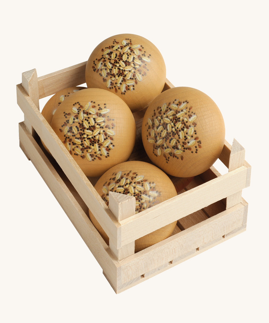 A selection of Erzi Wooden Seed Rolls, in a wooden Erzi crate, on a cream background