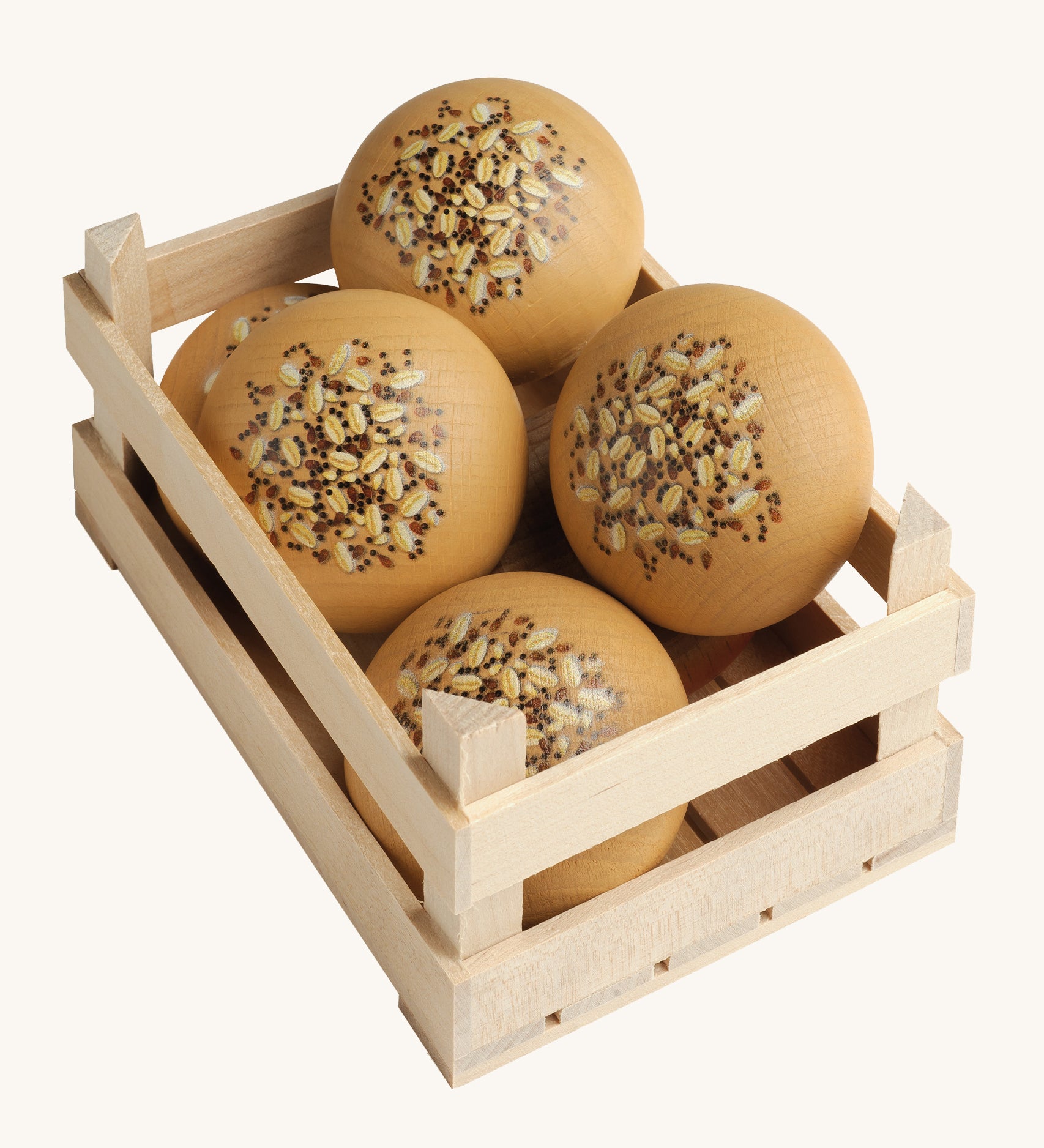 A selection of Erzi Wooden Seed Rolls, in a wooden Erzi crate, on a cream background