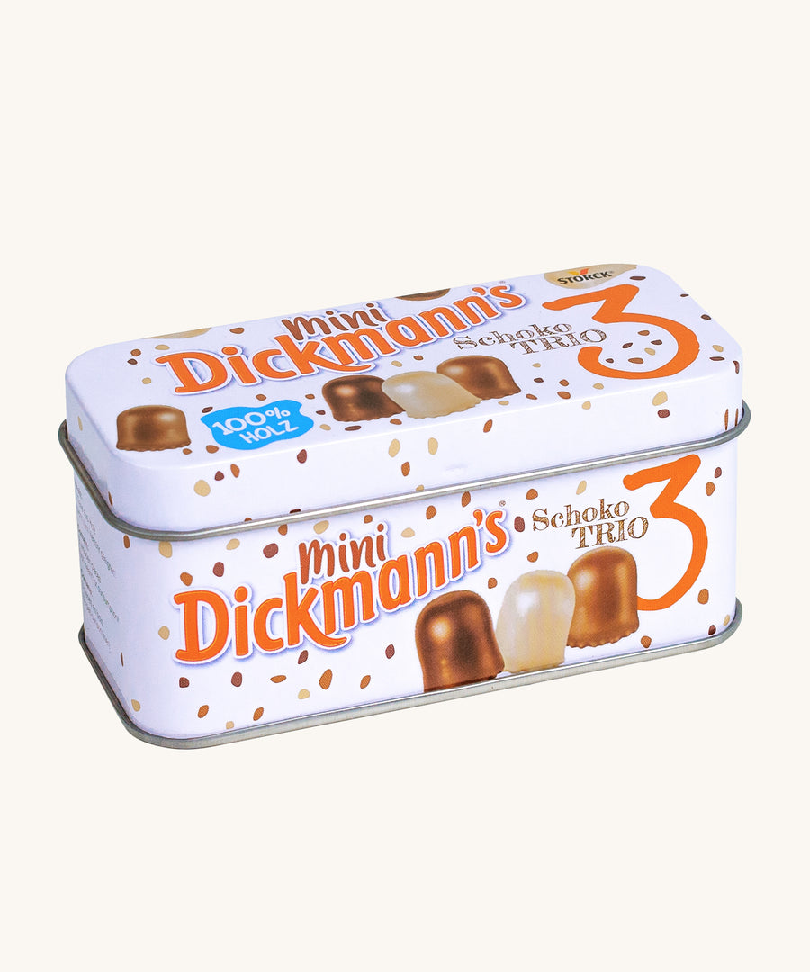 A closer look at the Marshmallow Trio tin on a cream background. A realistic Mini Dickmann's Schoko Trio tin in white, with chocolate coloured sprinkles and marshmallows