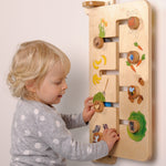 A child playing with the Erzi Baby Animal Wallboard Game. The image shows a child matching animals with their favourite food. A fantastic learning and play toy