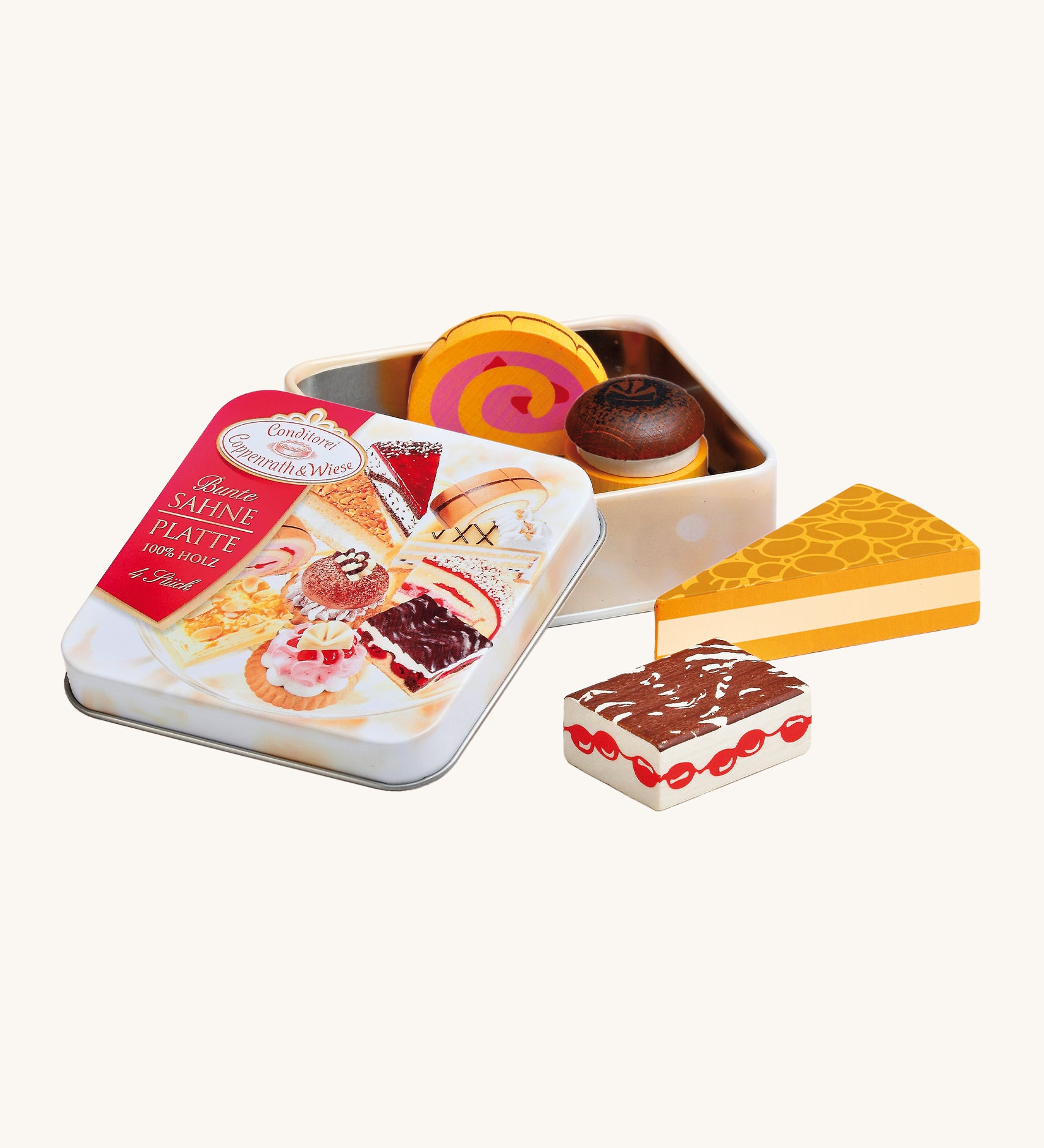 Erzi Wooden Cream Pastries In A Tin. A selection of wooden cream desserts and cakes, with a metal tin. On a cream background