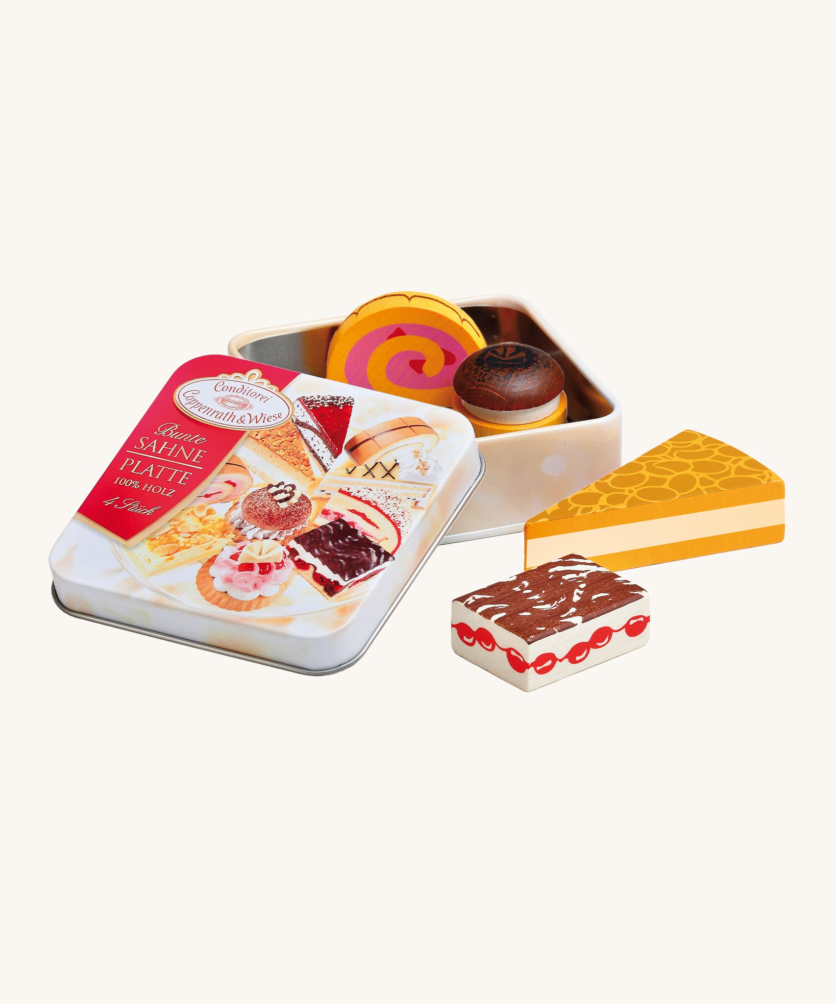 Erzi Wooden Cream Pastries In A Tin. A selection of wooden cream desserts and cakes, with a metal tin. On a cream background