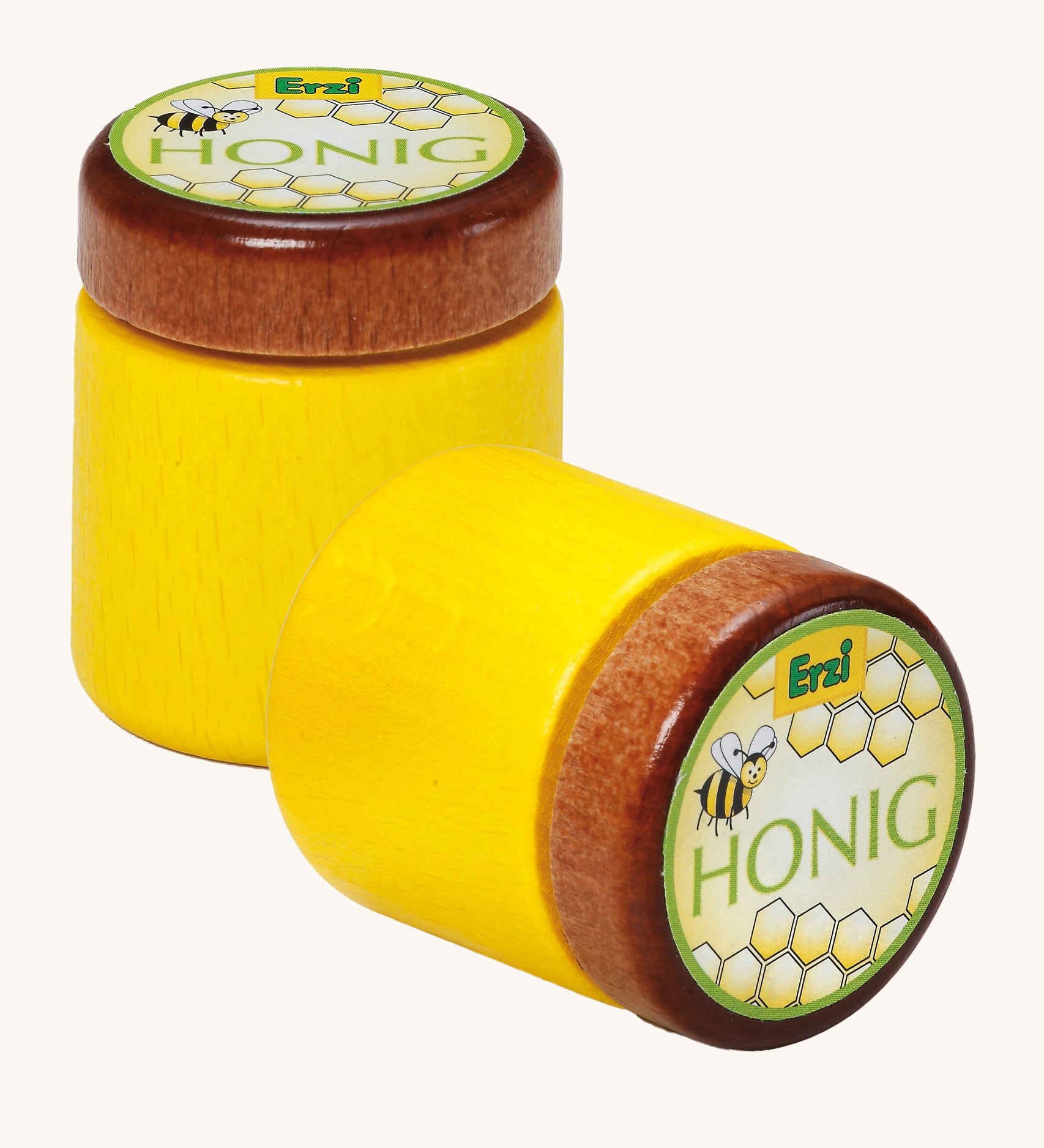 Two Erzi Wooden Honey Jar, one stood up and one laying down, on a cream background