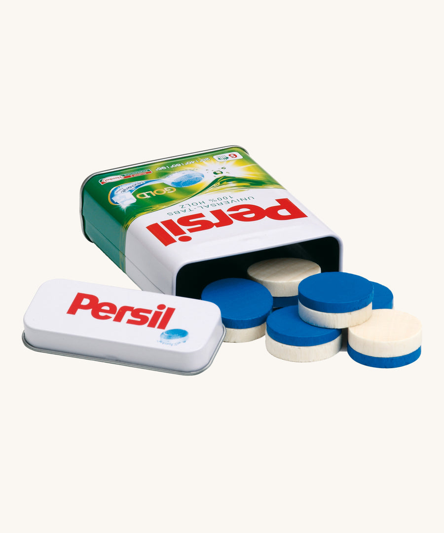 Erzi Wooden Laundry Detergent Tablets In A Tin. Colourful white and blue pretend laundry detergent tablets scattered in front of a realistic mini Persil tin. On a cream background