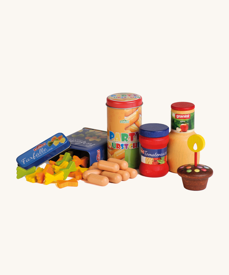 A closer look at the Erzi Wooden Party Food Set which includes pasta, party sausages, tomato sauce, apple juice, a cupcake and candle. On a cream background