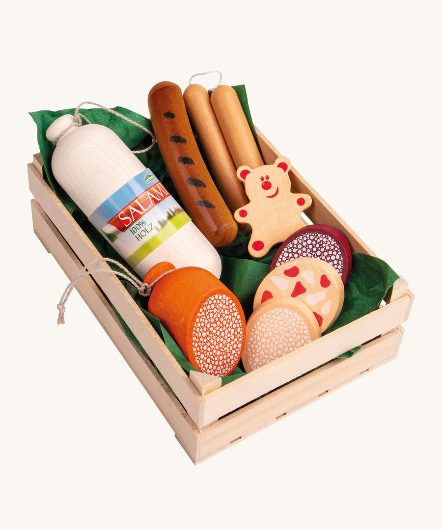 Erzi Wooden Assorted Sausages Play Food Set. A huge selection of play food sausages including different cuts of sausages, Salami, Wurst and Pepperoni together in a wooden Erzi crate lined with green paper. This would be a perfect set for playing cafes or shops!