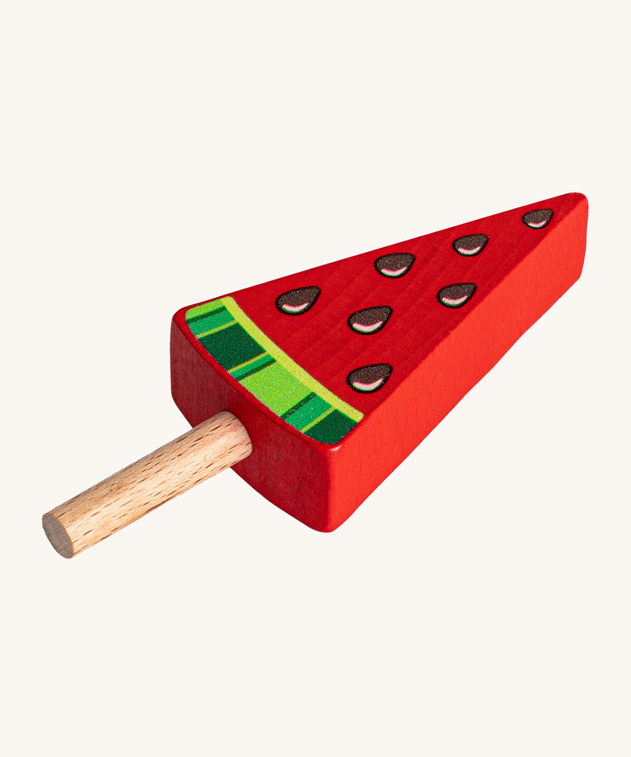 Erzi Wooden Melon Popsicle. A fun watermelon pretend play Popsicle, perfect for shop and cafe play! The popsicle is red with a natural wooden stick, watermelon seeds and green watermelon rind.