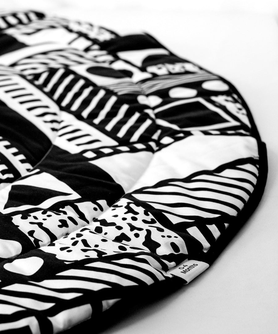 A closer look at the detailed monochromatic, black and white shapes on the Etta Loves x Camille Walala Reversible Playmat