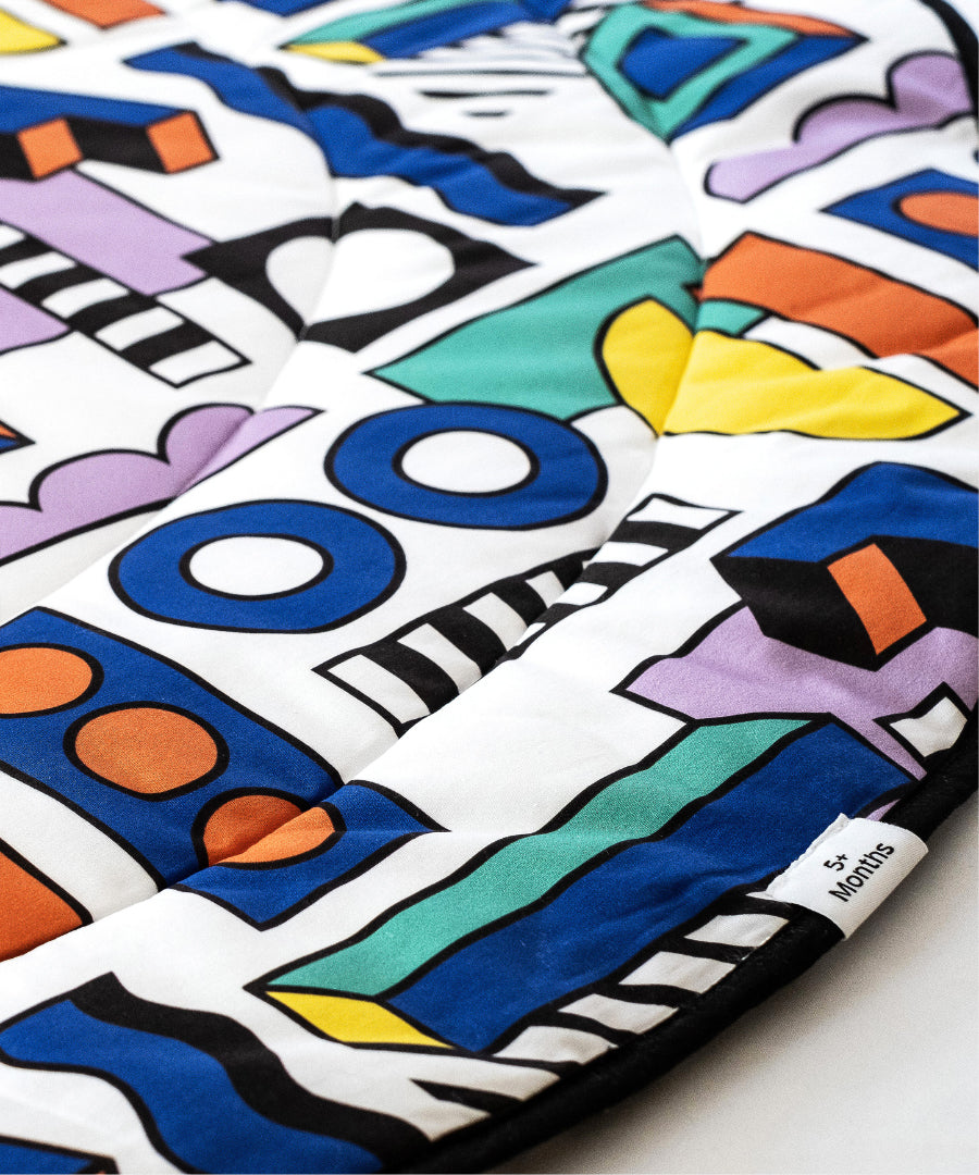 A closer look at the colourful print and shapes on the Etta Loves x Camille Walala Reversible Playmat