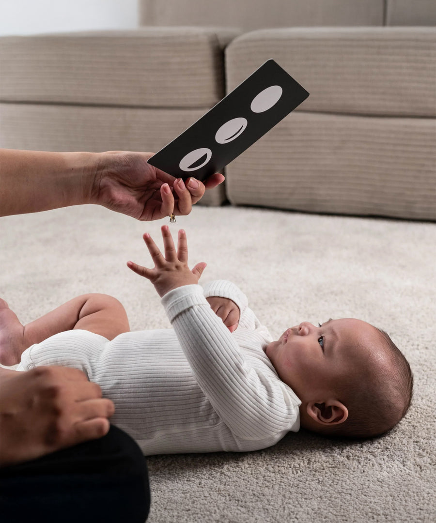 A parent playing with their child, using the Etta Loves Sensory Positive Affirmation Flash Cards