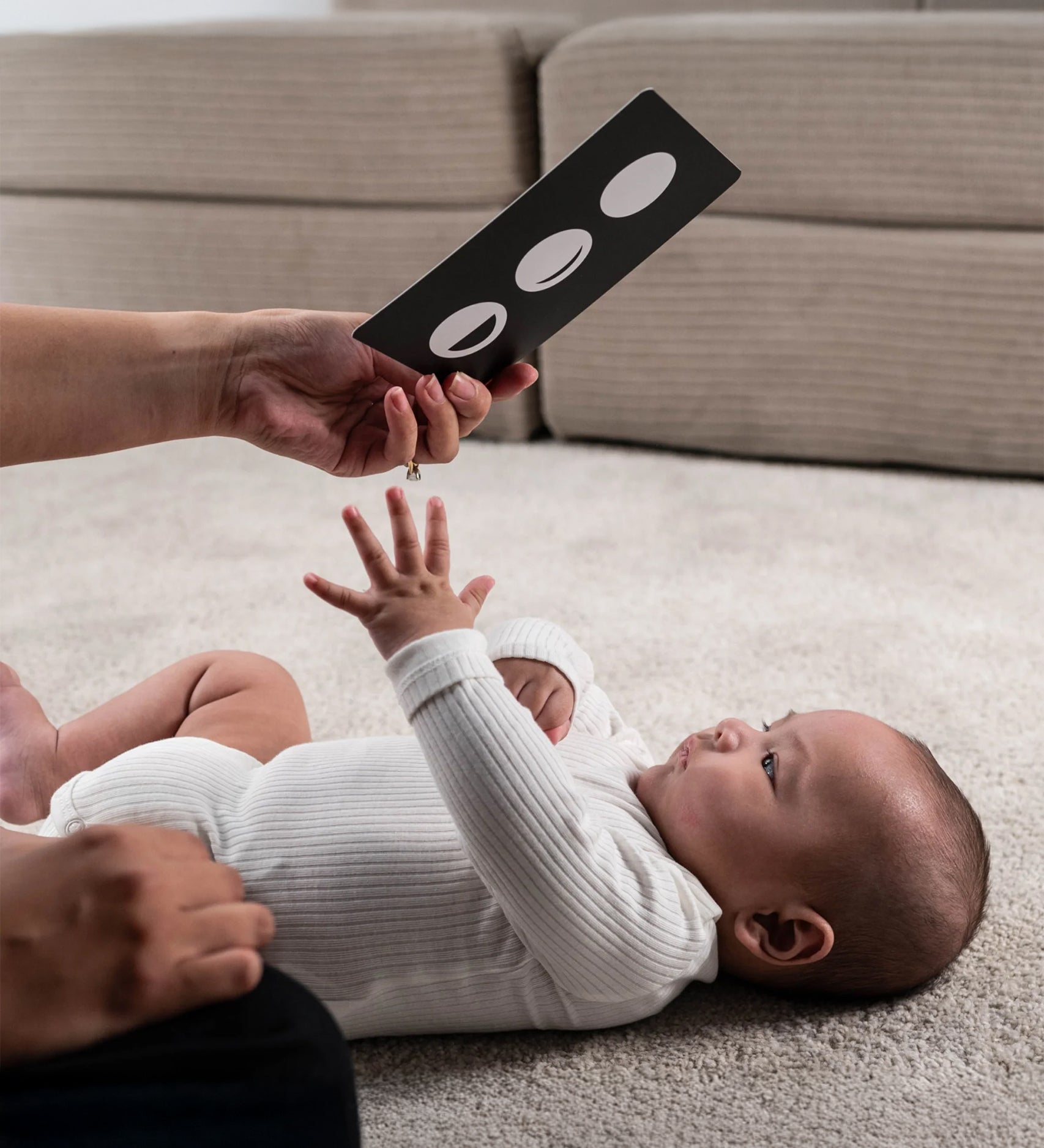 A parent playing with their child, using the Etta Loves Sensory Positive Affirmation Flash Cards