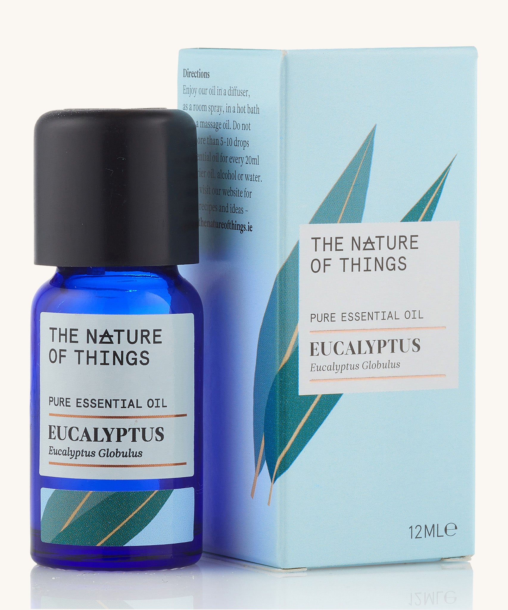 Organic Eucalyptus pure essential oil in a blue glass bottle in front of a decorative blue cardboard box.